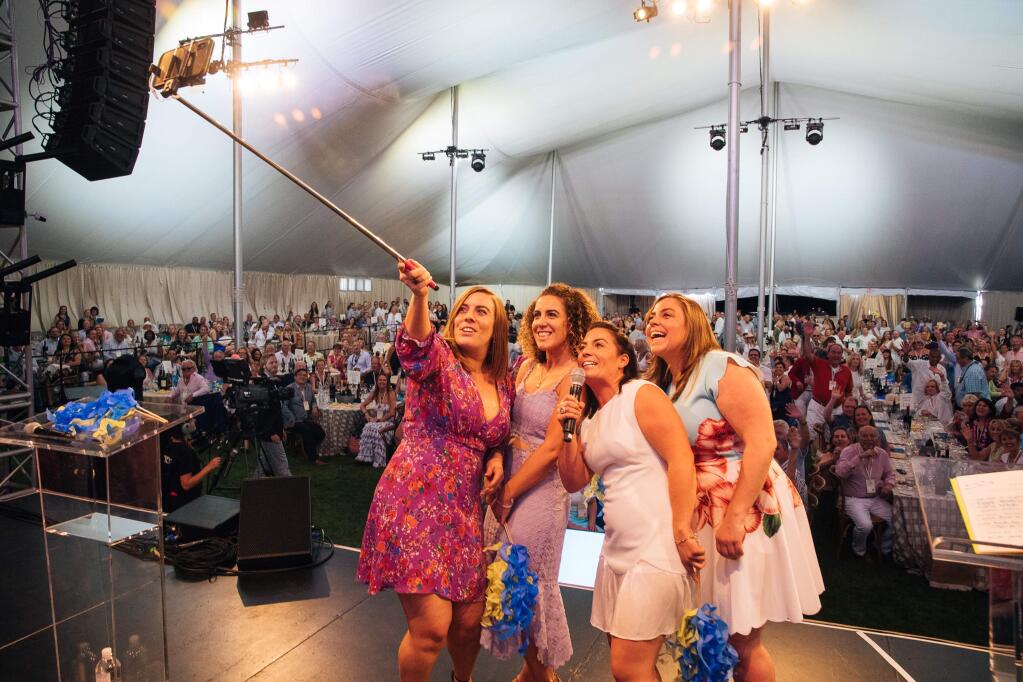 Auction Napa Valley 2018 leaders Riana, Giovanna, Alycia and Angelina Mondavi take a selfie at the live auction celebration at Meadowood Napa Valley on June 2, 2018. (Alexander Rubin / for Napa Valley Vintners)