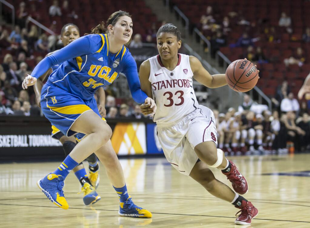 Stanford's Amber Orrange, right, drive to the basket as UCLA's Corinne Costa defends during the first half of an NCAA college basketball game in the quarterfinals of the Pac-12 Conference tournament, Friday, March 6, 2015, in Seattle. (AP Photo/Stephen Brashear)
