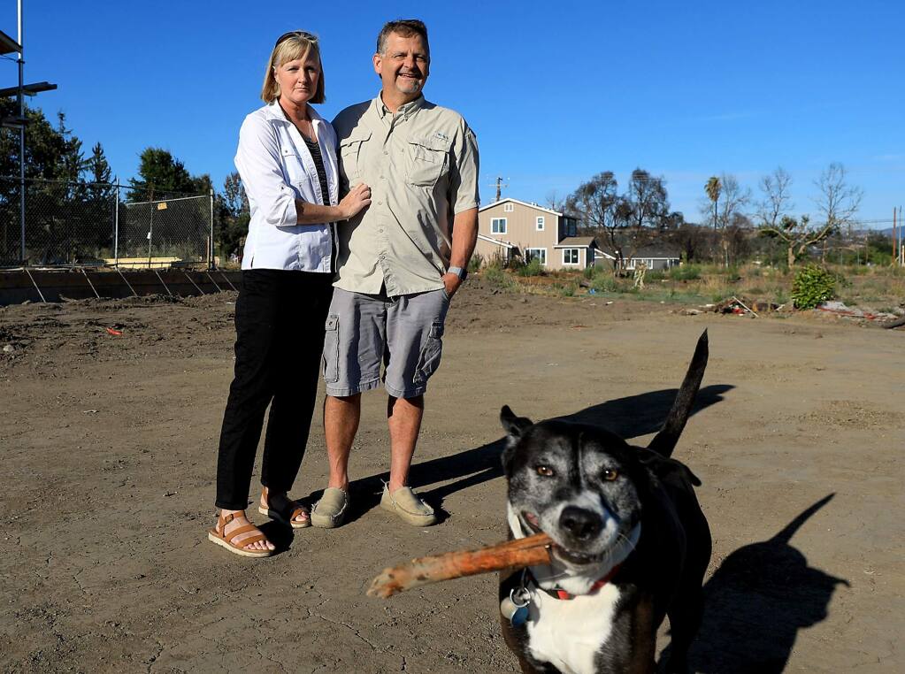 Sherinne and Doug Wilson, and their dog Daisy lost their home on Pine Meadow Place in Coffey Park to the Tubbs fire in October and plan to rebuild. Nine months after the fire, the Wilson's feel the effects of PTSD, Monday July 23, 2018 in Santa Rosa. (Kent Porter / The Press Democrat) 2018
