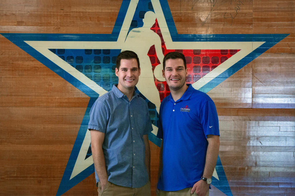 Ryan Channels (right) and Justin Channels, twin brothers and managers of California Roadshow Shop, at the new storefront location at 750 W. Napa St. on Monday, Sept. 18, 2023.The backdrop is a piece of the court from 2011 NBA All Stars game. (Robbi Pengelly/Index-Tribune)
