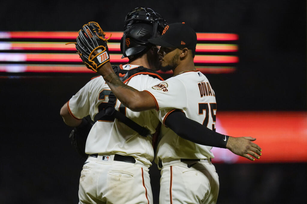 Giants relief pitcher Camilo Doval, right, celebrates with catcher Joey Bart after the Giants defeated the Chicago Cubs 4-2 in San Francisco, Thursday, July 28, 2022. (Godofredo A. Vásquez / ASSOCIATED PRESS)