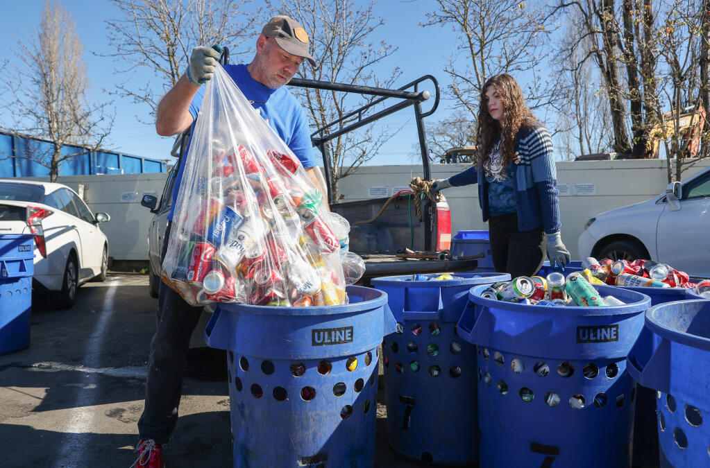 Sean Place and his daughter, Ashley, unload cans and bottles at a recycling center in Santa Rosa on Tuesday, Jan. 31, 2023. Sean Place founded the nonprofit Quetzal Ecology that raises funds for impoverished schools in central Mexico. (Christopher Chung / The Press Democrat)
