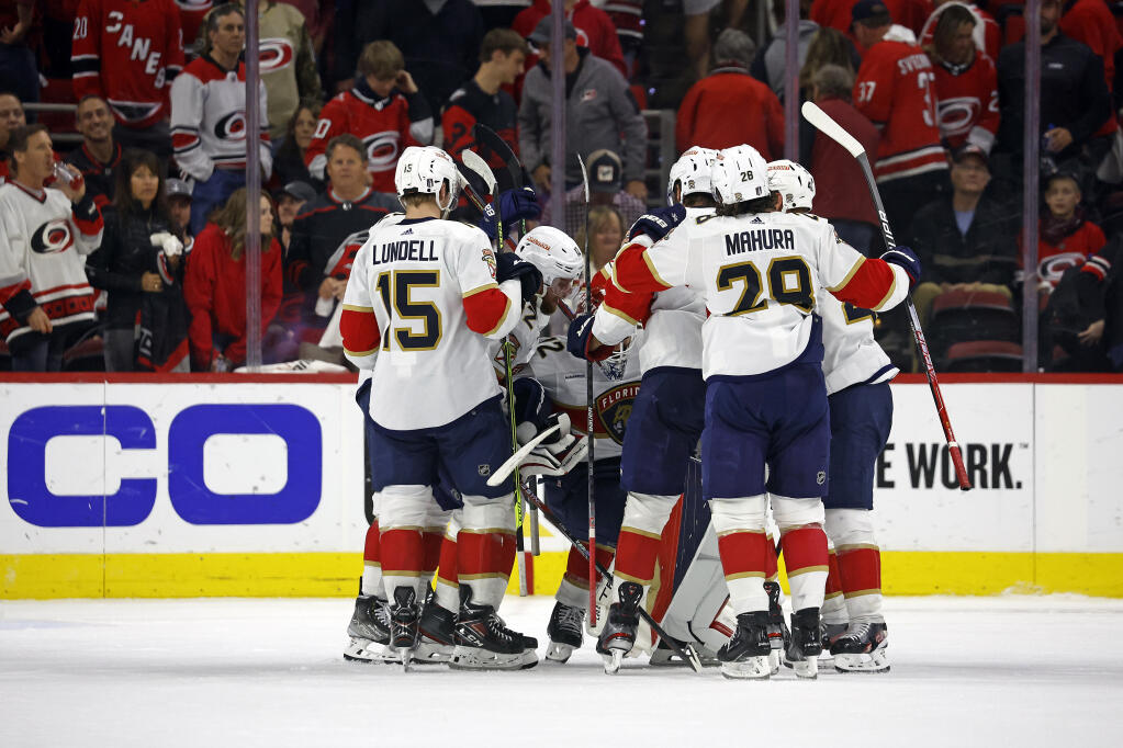 The Florida Panthers surround goaltender Sergei Bobrovsky following the team’s win 3-2 win over the Carolina Hurricanes in four overtimes in Game 1 of the Eastern Conference finals in Raleigh, North Carolina, early Friday, May 19, 2023. (Karl B. DeBlaker / ASSOCIATED PRESS)