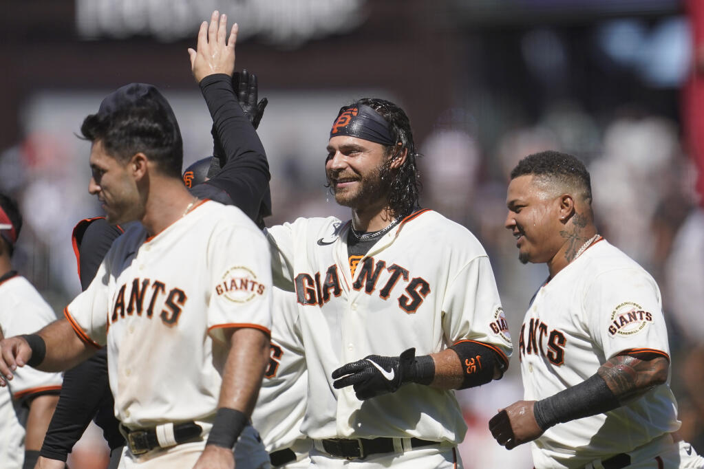The Giants’ Brandon Crawford, middle, celebrates with teammates after hitting an RBI single to drive in the winning run during the ninth inning against the Arizona Diamondbacks on Wednesday, July 13, 2022, in San Francisco. (Jeff Chiu / ASSOCIATED PRESS)
