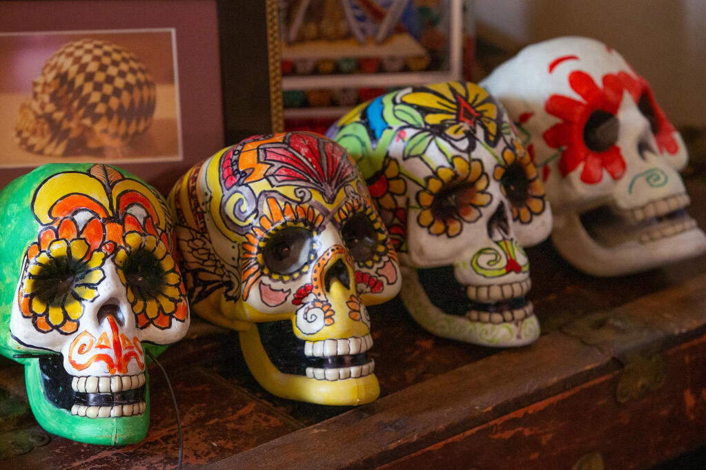 Painted skulls decorate part of a Dia de los Muertos altar created by artist Peter Perez at his home in Santa Rosa on Thursday, Oct. 22, 2020. (Alvin A.H. Jornada / The Press Democrat)
