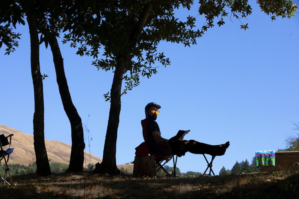 Kevin Nazario of Oakland enjoys a book in the shade of a tree in the campground at Sugarloaf State Park on Monday. Sonoma County Regional Parks Foundation has created the “Bill & Dave Legacy Fund” in honor of Bill Myers and Dave Chalk, long-time leaders of the popular Bill & Dave’s Hikes.  (John Burgess/The Press Democrat)