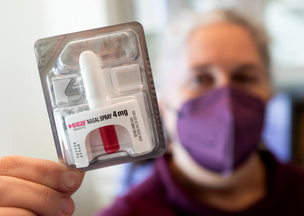 Director Rebecca Norwick holds a dose of Narcan nasal spray used for fentanyl overdoses at the SRJC Health Services in Santa Rosa, Wednesday, Feb. 8, 2023. A new state bill requires CSU and community colleges to provide opioid overdose prevention info and resources to students, including Narcan. (John Burgess/The Press Democrat)