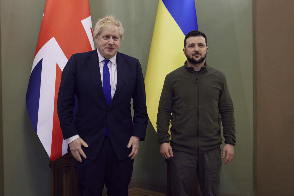 In this image provided by the Ukrainian Presidential Press Office, Britain's Prime Minister Boris Johnson, left and Ukrainian President Volodymyr Zelenskyy pose for a photo, in Kyiv, Ukraine, Saturday, April 9, 2022.  Johnson has traveled to Ukraine to meet with President Volodymyr Zelenskyy in show of solidarity. The two leaders meeting Saturday discussed the “U.K.’s long term support to Ukraine’’ including a new package of financial and military aid, the prime minister’s office said. (Ukrainian Presidential Press Office via AP)