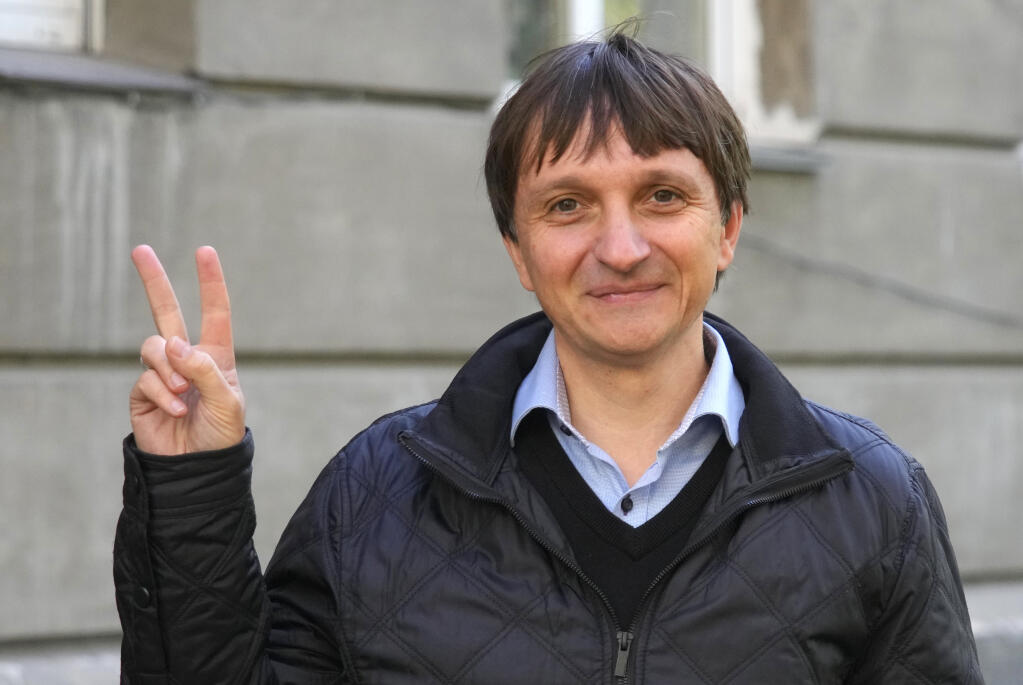 Volodymyr Yavorskyi, the expert of the Center of Civil Liberties, shows a V-sign in Kyiv, Ukraine, Friday, Oct. 7, 2022. On Friday, Oct. 7, 2022 the Nobel Peace Prize was awarded to jailed Belarus rights activist Ales Bialiatski, the Russian group Memorial and the Ukrainian organization Center for Civil Liberties. (AP Photo/Efrem Lukatsky)