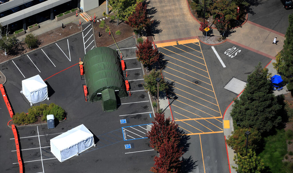 Near the parking garage and adjacent to the Emergency Department entrance at Kaiser Permanente Santa Rosa Medical Center and Medical Offices, surge tents were re-installed as a precaution for the recent COVID-19 surge, Wednesday, Aug. 25, 2021.  (Kent Porter / The Press Democrat) 2021