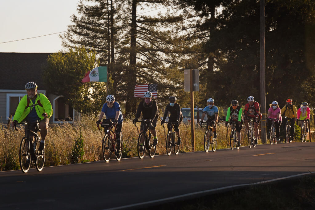 Riders heading down Todd Road during the international Ride of Silence, an event to remember fellow cyclists who have been killed or injured riding on public roadways, held in Santa Rosa, California, on Wednesday, May 19, 2021. (Erik Castro / For The Press Democrat)