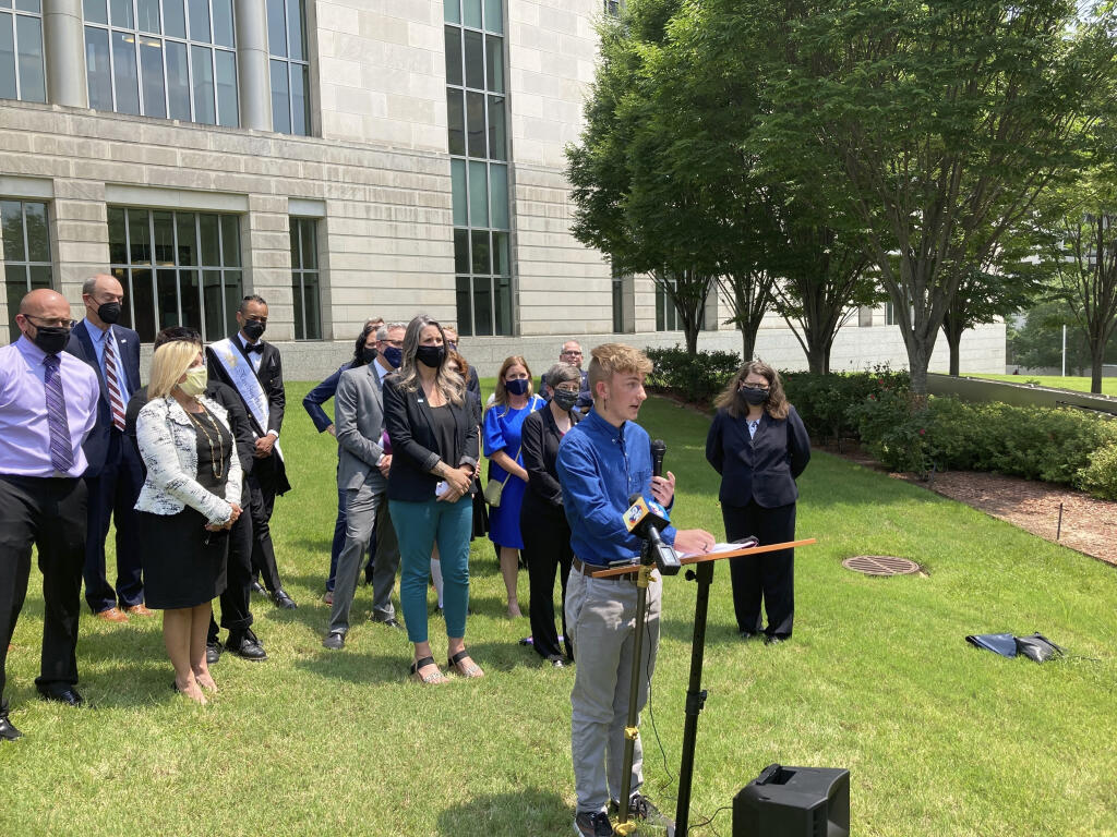FILE - Dylan Brandt speaks at a news conference outside the federal courthouse in Little Rock, Ark., July 21, 2021. Brandt, a teenager, is among several transgender youth and families who are plaintiffs challenging a state law banning gender confirming care for trans minors. The nation’s first trial over a state’s ban on gender-confirming care for children begins in Arkansas on Monday, Oct. 17, 2022, the latest fight over restrictions on transgender youth championed by Republican leaders and widely condemned by medical experts. (AP Photo/Andrew DeMillo, File)