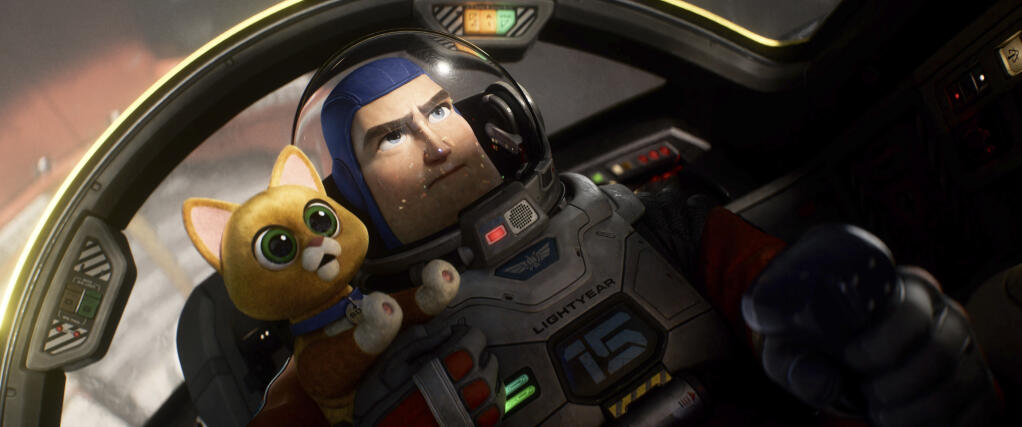 This image released by Disney/Pixar shows character Buzz Lightyear, voiced by Chris Evans, and  Sox, voiced by Peter Sohn, in a scene from the animated film "Lightyear," releasing June 17. (Disney/Pixar via AP)