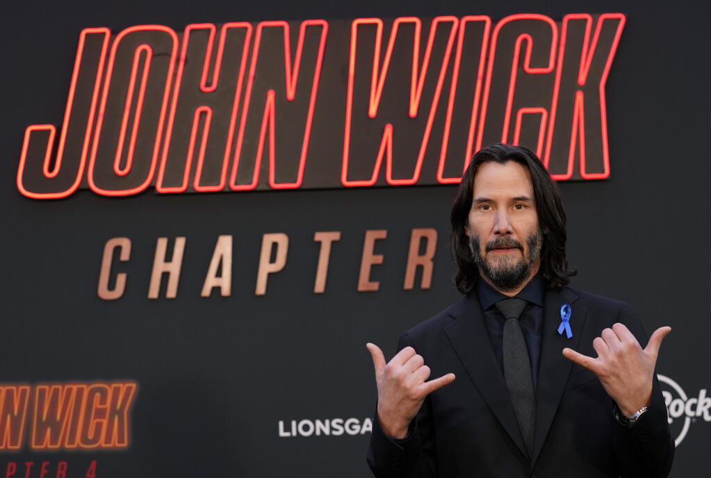 Keanu Reeves, star of "John Wick: Chapter 4," poses at the premiere of the film, Monday, March 20, 2023, at the TCL Chinese Theatre in Los Angeles. (AP Photo/Chris Pizzello)