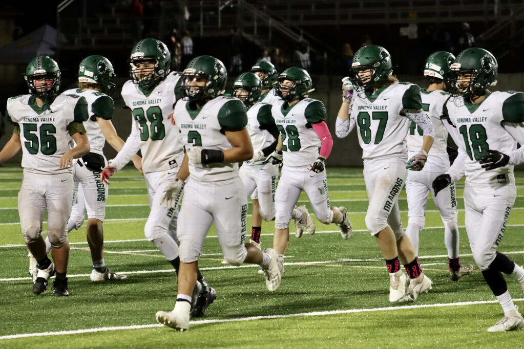 Sonoma Valley Dragons' defense comes off the field with smiles following a third-quarter interception by Junior Meza (#3). It was a highlight of the 66-14 loss at the hands of the Vintage Crushers on Oct. 22, 2021. (Caya Aronson/Index-Tribune)