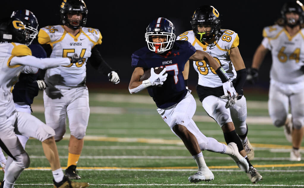 Sailasa Vadrawale of Rancho Cotate threads the Granada defense as he rolls to a first down, Friday, Nov. 12, 2021 in Rohnert Park. (Kent Porter / The Press Democrat)