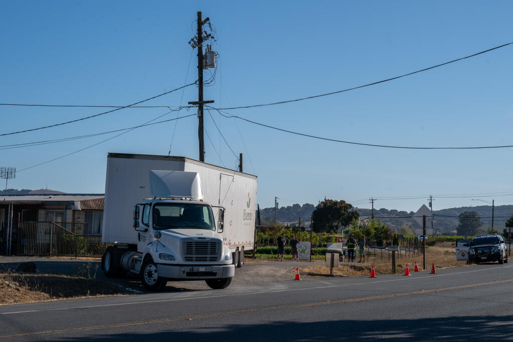 Power lines lay on the back of a semitrailer that clipped the side of a power pole across from Brocco’s Old Barn in the late afternoon of Thursday, Sept. 28, 2023 in Sonoma. (Nicholas Vides / For The Press Democrat)