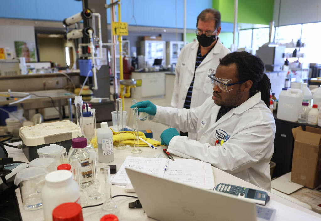 Chemical engineer Nehemiah Ceasar, right, works on direct osmosis to desalt water, while Ken Semore watches, at Trevi Systems Inc. in Rohnert Park on Tuesday, Aug. 30, 2022.  (Christopher Chung/The Press Democrat)