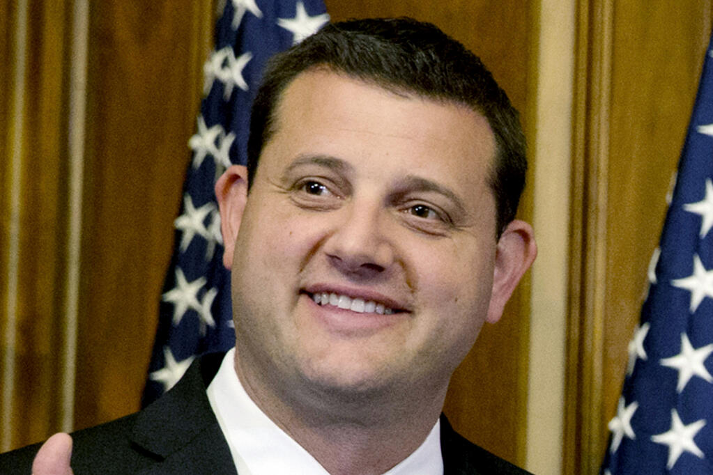 FILE - U.S. Rep. David Valadao, R-Calif., poses during a ceremonial re-enactment of his swearing-in ceremony in the Rayburn Room on Capitol Hill in Washington on Jan. 6, 2015. Valadao is trying to win a return trip to Congress. He's proven resilient before. Valadao, who emphasizes a bipartisan streak, has won in a heavily Democratic, largely Latino district before. He held his seat from 2013 until January 2019, lost it for a term, then won it back in a 2020 rematch with Democrat T.J. Cox. He's facing Democrat Rudy Salas in a newly redrawn district. (AP Photo/Jacquelyn Martin, File)