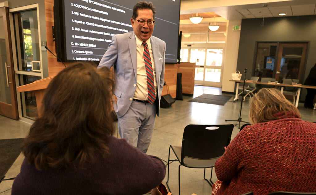 Sandy Sigala, left, and Debbie Weatherly talk with Santa Rosa Junior College president Dr. Frank Chong prior to a board meeting where Chong is announcing his retirement, Tuesday, Oct. 11, 2022 at the SRJC campus in Petaluma.   (Kent Porter / The Press Democrat) 2022