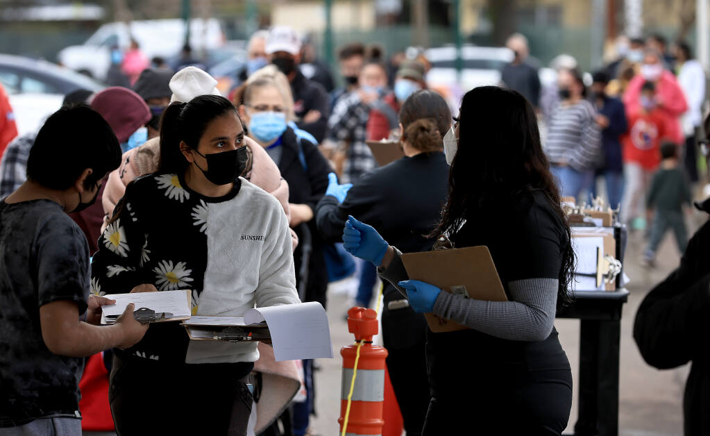 At the Roseland Community Center in Santa Rosa, a long of people wait to be tested for COVID-19 on Wednesday, Jan. 5, 2022. (Kent Porter / The Press Democrat)