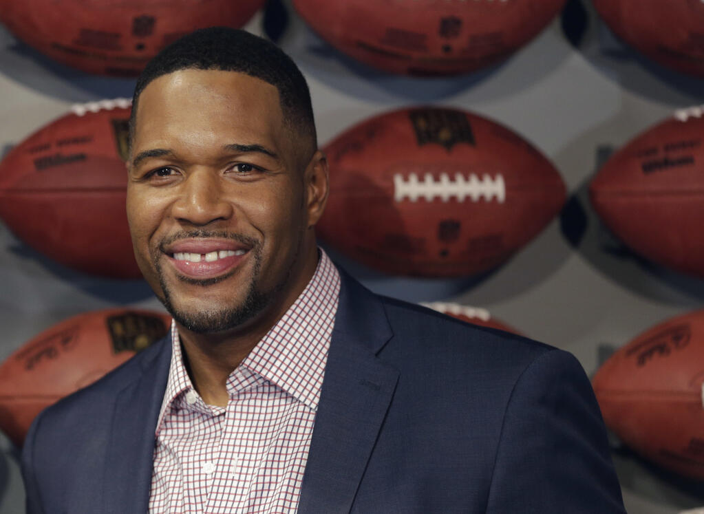 FILE - In this Thursday, Nov. 30, 2017 file photo, Former New York Giant Michael Strahan poses for a picture at the opening of "NFL Experience" in Times Square, New York. Pro Football Hall of Famer and “Good Morning America” host Michael Strahan has tested positive for COVID-19 and is self-quarantining, according to people familiar with the situation. They spoke to The Associated Press on condition of anonymity Wednesday, Jan. 27, 2021 because of medical restriction issues. (AP Photo/Seth Wenig, File)