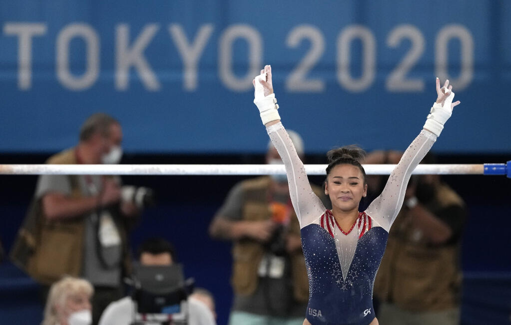 Sunisa Lee, of the United States, finishes on the uneven bars during the artistic gymnastics women's all-around final at the 2020 Summer Olympics, Thursday, July 29, 2021, in Tokyo. (AP Photo/Ashley Landis)