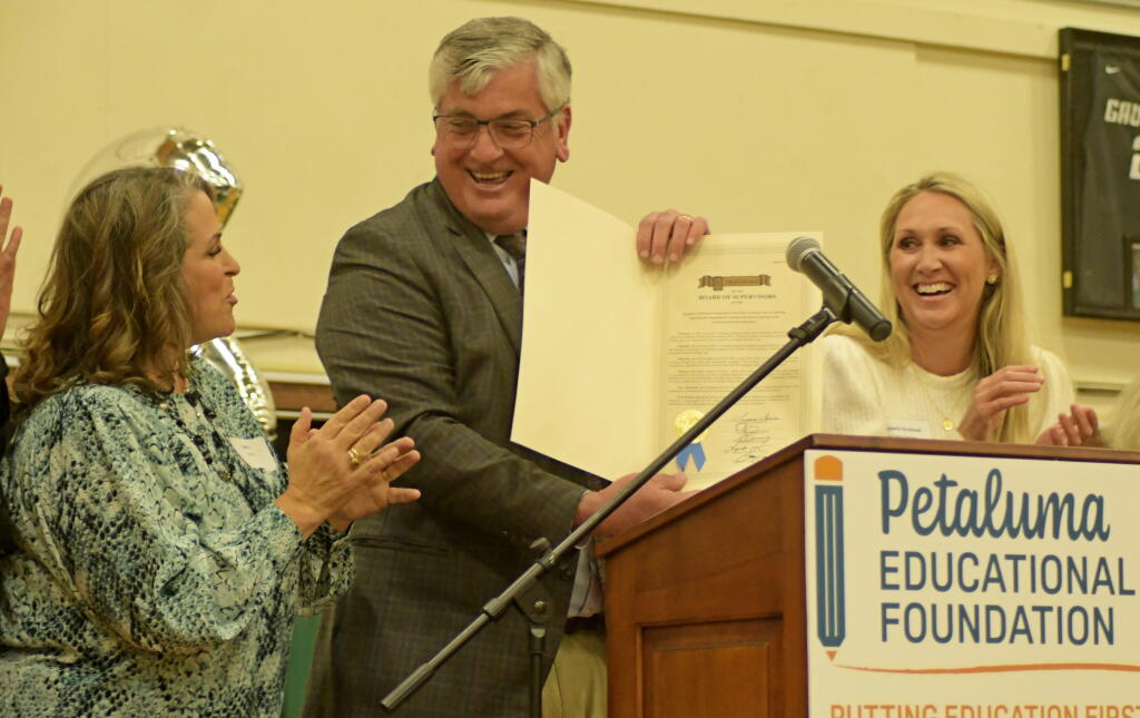 Sonoma County Supervisor David Rabbit presents a resolution of commendatiojn from the county to Petaluma Educational Foundation Program Director Katy Verke and PEF Board Member Kimberly Strickland. (SUMNER FOWLER / FOR THE ARGUS-COURIER)