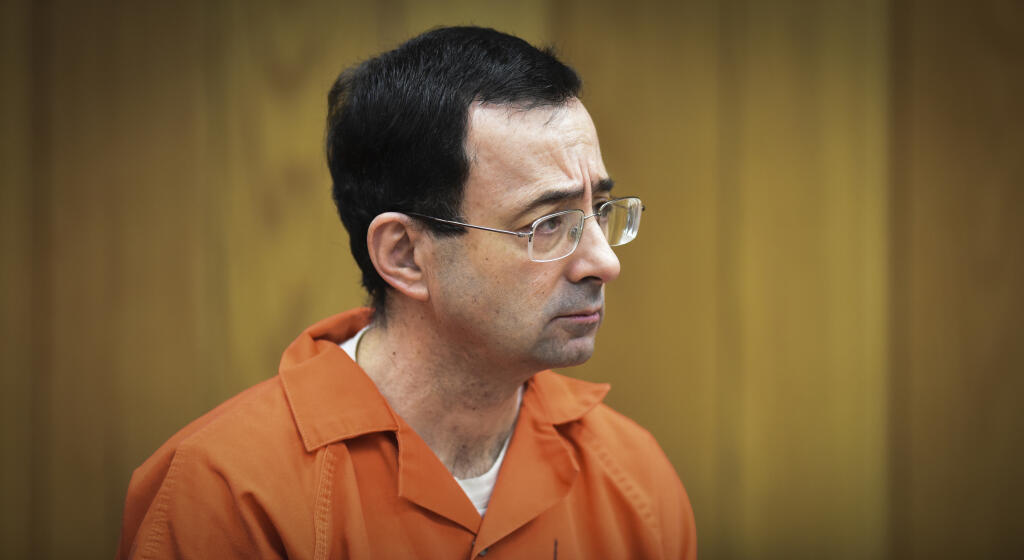 FILE - In this Feb. 5, 2018 file photo, Larry Nassar, former sports doctor who admitted molesting some of the nation's top gymnasts, appears in Eaton County Court in Charlotte, Mich. Thirteen sexual assault victims of Nassar are seeking $10 million each from the FBI, claiming a bungled investigation by agents led to more abuse by the sports doctor, lawyers said Thursday, April 21, 2022. (Matthew Dae Smith/Lansing State Journal via AP, File)