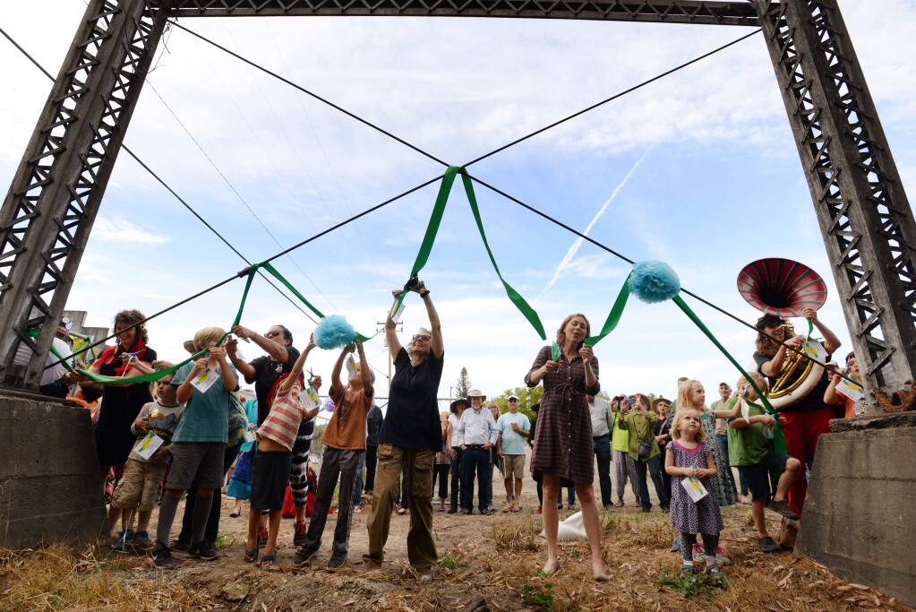 Supervisor Lynda Hopkins, right, joined several children during the ribbon cutting ceremony near the old water tower in what will eventually become Graton Green during a celebration of Graton's New Green held Sunday at the Graton Day Labor Center in Graton, California. September 30, 2018.(Photo: Erik Castro/for The Press Democrat)