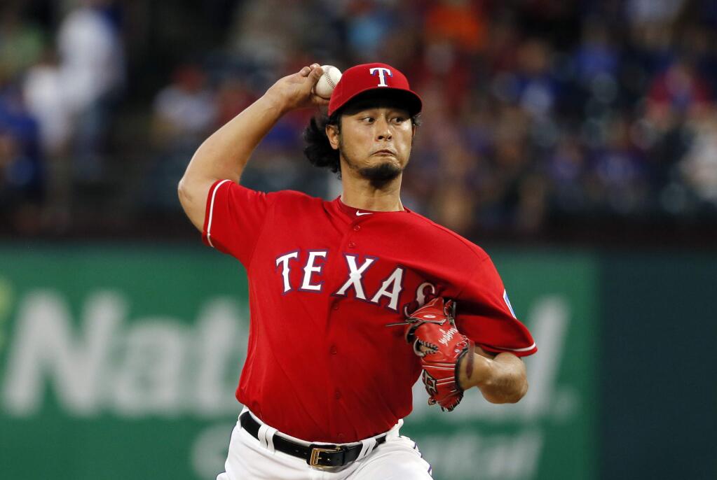 Texas Rangers' Yu Darvish works against the Oakland Athletics during the first inning of a baseball game, Wednesday, Aug. 17, 2016, in Arlington, Texas. (AP Photo/Tony Gutierrez)