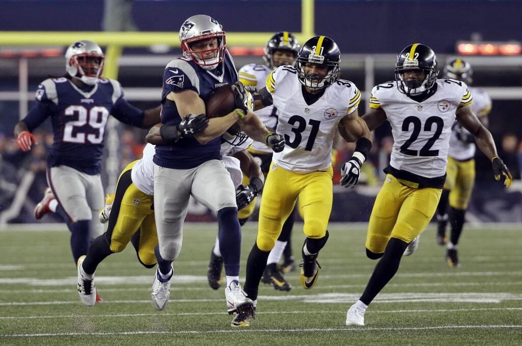 New England Patriots wide receiver Chris Hogan (15) runs against Pittsburgh Steelers defense during the second half of the AFC championship NFL football game, Sunday, Jan. 22, 2017, in Foxborough, Mass. (AP Photo/Elise Amendola)