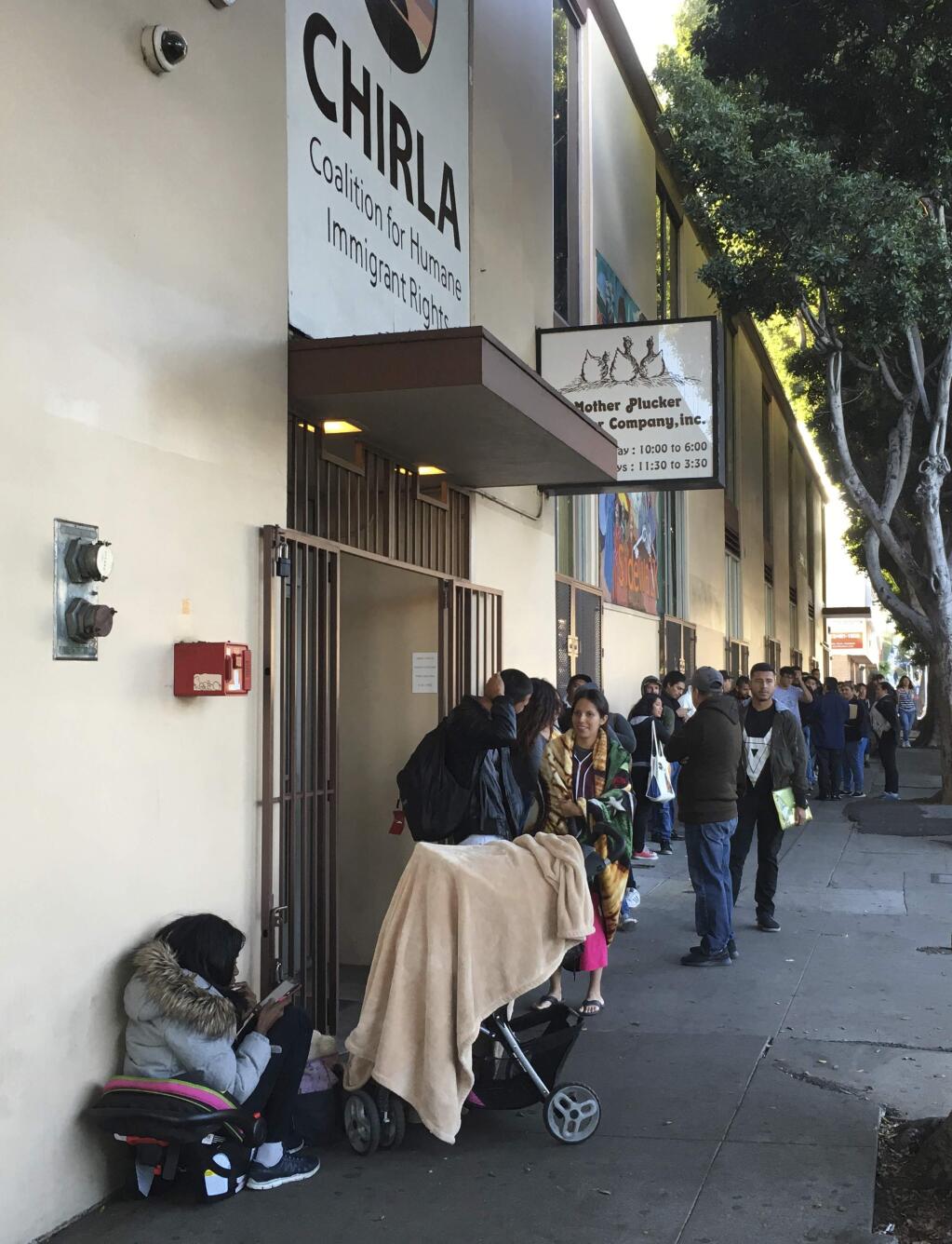 This Sept. 28, 2017 photo shows people waiting in line at CHIRLA (Coalition for Humane Immigrant Rights Los Angeles) for help with immigration paperwork, including renewing work permits for expiring Obama-era program for immigrants brought to the country as children. After Oct. 5, 2017, no one else can renew under the program that has let nearly 800,000 immigrants brought to the United States as children work in the country even though they lack legal papers. (AP Photo/Amy Taxin)