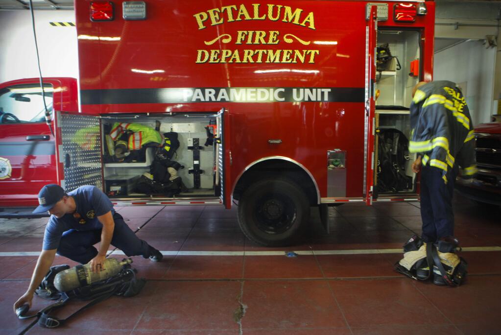 Firefighter/Paramedic Jamin Perkins (left) and firefighter Matt Dealba checkout the rigs at Station One in downtown Petaluma at the beginning of their shift. (CRISTINA PASCUAL/ARGUS-COURIER STAFF)