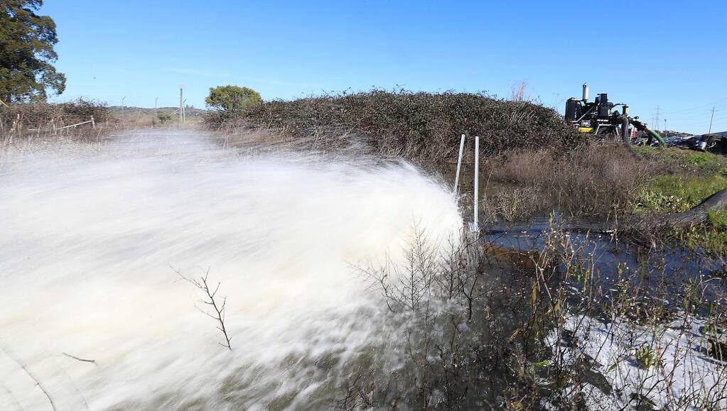 Water from recent storms is pumped out at westbound Highway 37 on Tuesday, Feb. 19, 2019, near Atherton. (KENT PORTER/ PD)