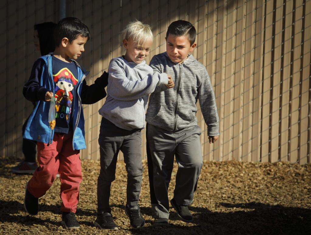 Petaluma, CA, USA. Friday, February 07, 2020._ Kindergartners at Loma Vista Immersion Academy, Liam Smith, Finnley Smith and Didier Valencia (right) play together outside the classroom during snack time. (CRISSY PASCUAL/ARGUS-COURIER STAFF)