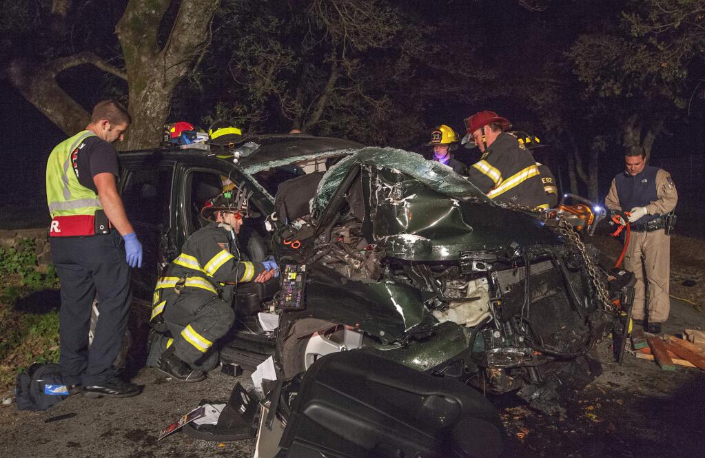 Firefighters work to free a Sonoma man trapped in his crushed Jeep Cherokee following a single-car crash on Carriger Road on Tuesday, Jan. 20. Photo by Robbi Pengelly/Index-Tribune.