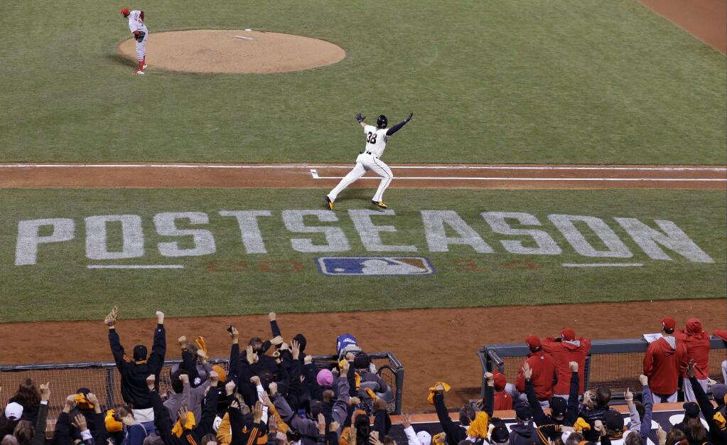 San Francisco Giants' Michael Morse reacts as he crosses home after hitting a home run during the eighth inning of Game 5 of the National League baseball championship series against the St. Louis Cardinals Thursday, Oct. 16, 2014, in San Francisco. (AP Photo/David J. Phillip)