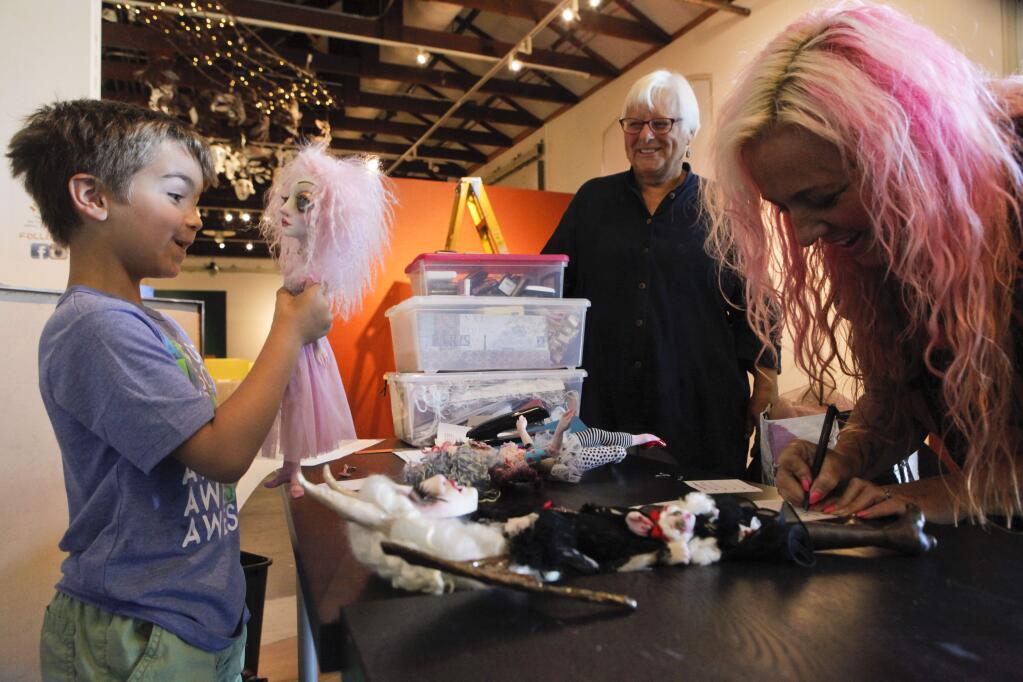 Petaluma, CA, USA. Monday, July 18, 2016._ Nicholas Calabrese, 6 of Santa Rosa (Left) exclaims his adoration for a doll that was made by artist Sheri DeBow,48 of Napa (R) who dropped off her dolls which can be viewed at The Petaluma Arts Center's upcoming exhibit,'Journeys Through Light & Dark: Dolls as Tellers of Stories.' Nicholas' grandmother, Geri Olson, 67 of Petaluma (center) will also have dolls featured in the show.(CRISSY PASCUAL/ARGUS-COURIER STAFF)
