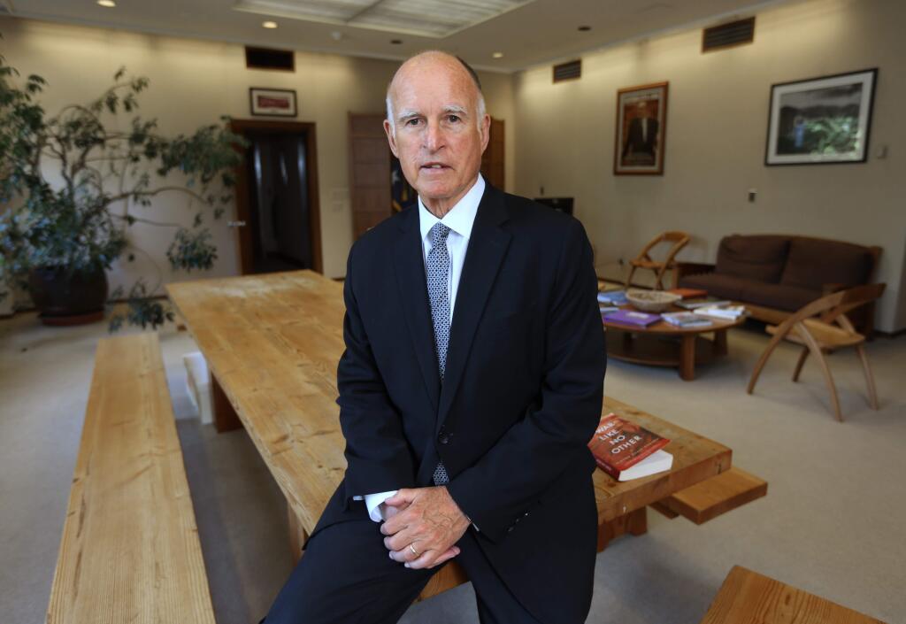 FILE - In this May 28, 2014, file photo, Gov. Jerry Brown poses in his Capitol office in Sacramento, Calif. Incumbent Brown faces Republican Neel Kashkari, a former U.S. Treasury official who has never held elective office, in the November election. Brown, 76, is on the verge of doing what no one else has ever done in California: get elected to a fourth term as governor. (AP Photo/Rich Pedroncelli, File)