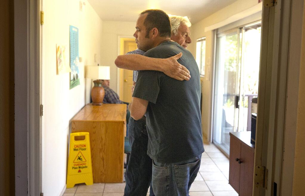 Peter Lloyd gives his son Robert a hug at the Hope House, a residential care facility for those with mental illness in Santa Rosa. Robert, who is diagnosed with schizophrenia, has learned to give hugs and function better in society after 2 years at the home. (photo by John Burgess/The Press Democrat)