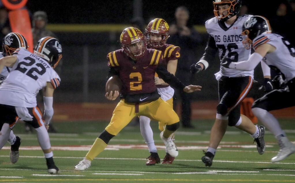 Cardinal Newman's Giancarlo Woods splits the Los Gatos defense, Friday, Dec. 6, 2019 en route to a state championship birth. (Kent Porter / The Press Democrat) 2019