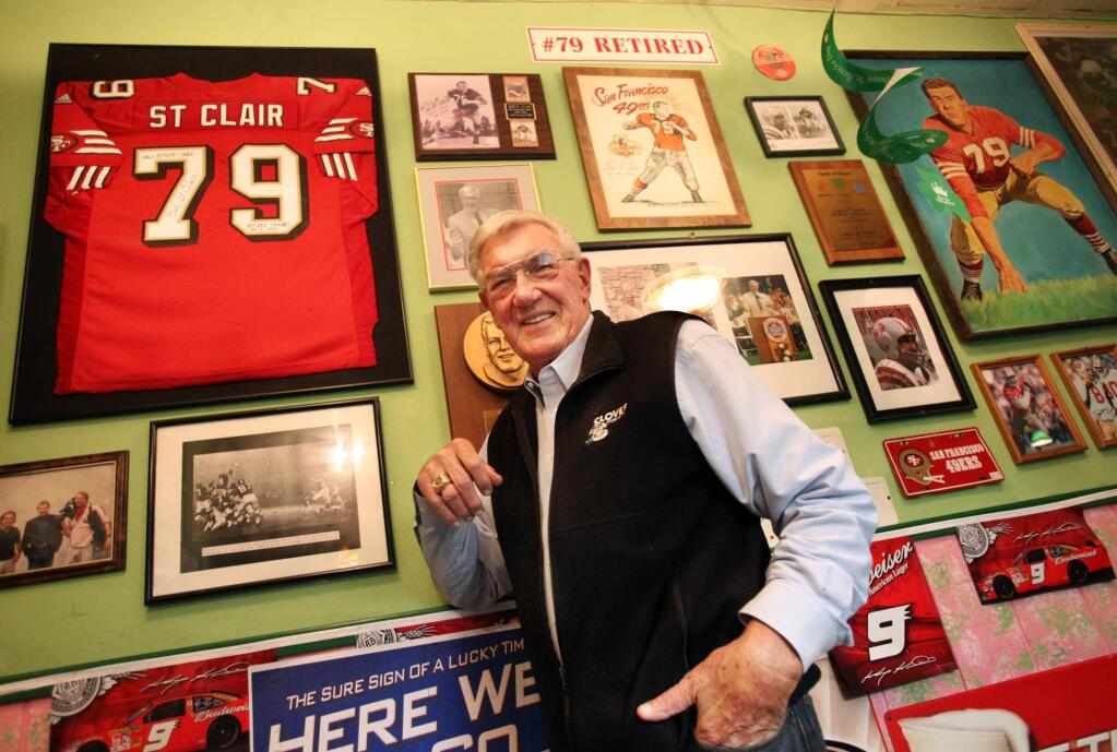 Pro Football Hall of Famer Bob St. Clair stands in front of a wall dedicated to him at the Nutty Irishman Restaurant in Santa Rosa, March 16, 2010. St. Clair was drafted by the San Francisco 49ers in 1953. St. Clair died Monday, April 20, 2015. He was 84. (CRISTA JEREMIASON/ PD FILE)