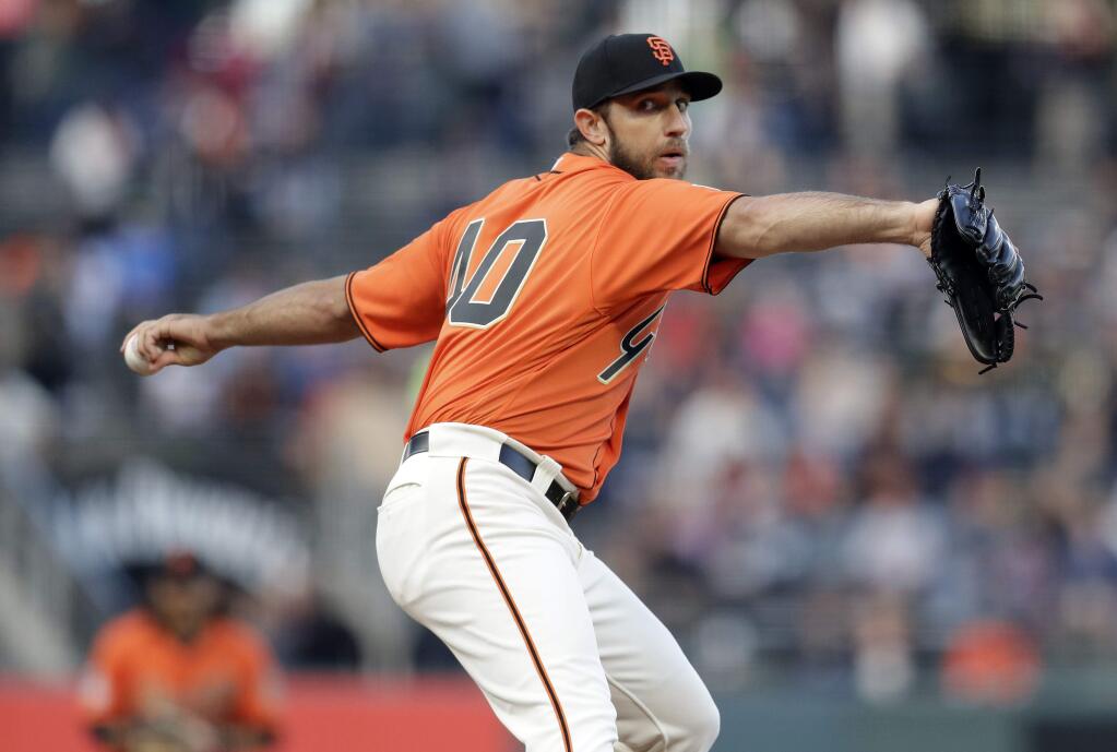 San Francisco Giants starting pitcher Madison Bumgarner throws to an Oakland Athletics batter during the first inning Friday, July 13, 2018, in San Francisco. (AP Photo/Marcio Jose Sanchez)