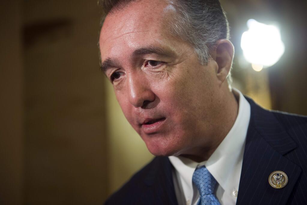 FILE - In this March 24, 2017, file photo, Rep. Trent Franks, R-Ariz. speaks with a reporter on Capitol Hill in Washington. Franks says he is resigning Jan. 31 amid a House Ethics Committee investigation of possible sexual harassment. Franks says in a statement that he never physically intimidated, coerced or attempted to have any sexual contact with any member of his congressional staff. Instead, he says, the dispute resulted from a discussion of surrogacy. Franks and his wife have 3-year-old twins who were conceived through surrogacy. (AP Photo/Cliff Owen, File)