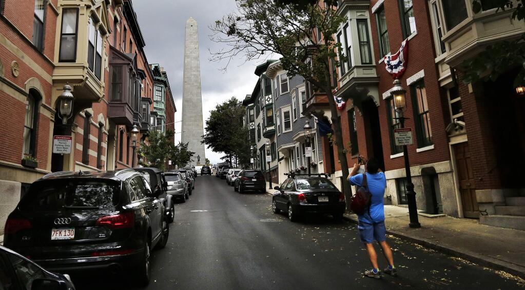 In this Tuesday, June 28, 2016 photo, a tourist snaps a picture of the Bunker Hill monument, which is located on Breed's Hill in the Charlestown neighborhood of Boston. The Battle of Bunker Hill, one of the greatest misnomers in U.S. history, is being waged anew on social media. The 1775 battle, a pivotal rallying point for American colonists trying to overthrow British rule, actually was fought on Breed's Hill, not Bunker Hill. (AP Photo/Charles Krupa)