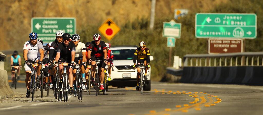 Riders bike across the Russian River near Jenner in Levi's GranFondo through west Sonoma County on Saturday, October 4, 2014.