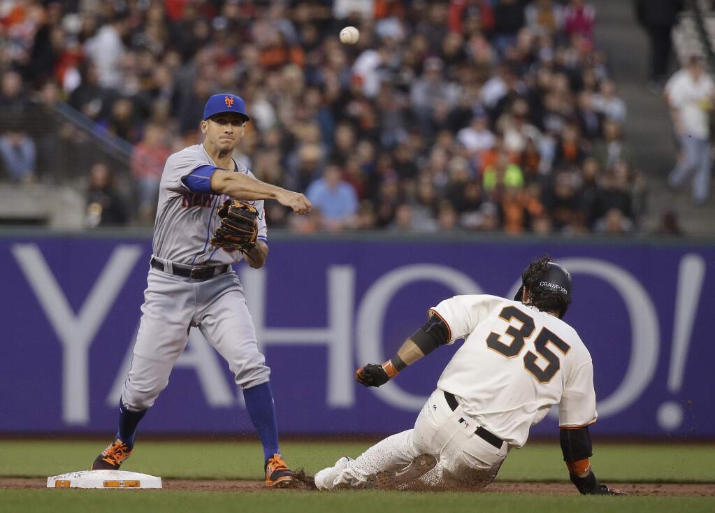 New York Mets second baseman T.J. Rivera turns a double play as San Francisco Giants' Brandon Crawford (35) slides into second base during the second inning Thursday, Aug. 18, 2016, in San Francisco. Out at first base on the play was Hunter Pence. (AP Photo/Eric Risberg)