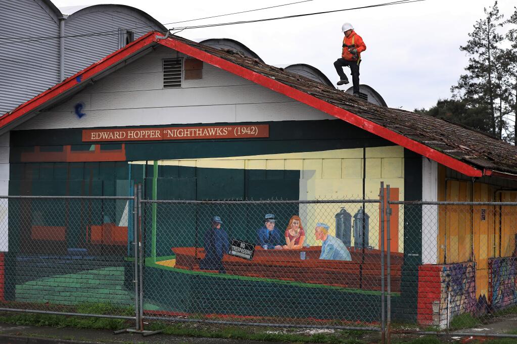 Crews are busy tearing down a building that displays local artists' work at the corner of Cleveland and College avenues in Santa Rosa on Monday, Jan. 14, 2019. (KENT PORTER/ PD)
