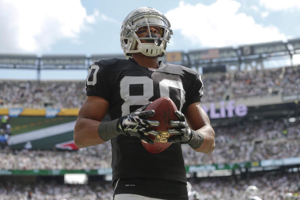 Oakland Raiders' Rod Streater (80) reacts after scoring a touchdown during the first half of an NFL football game against the New York Jets Sunday, Sept. 7, 2014, in East Rutherford, N.J. (AP Photo/Seth Wenig)